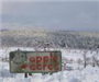 Apple Acres Sign During Winter Snow